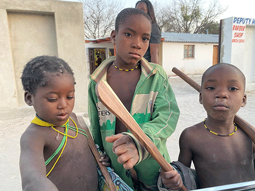 Angolan minors scrounge in  bins for food
